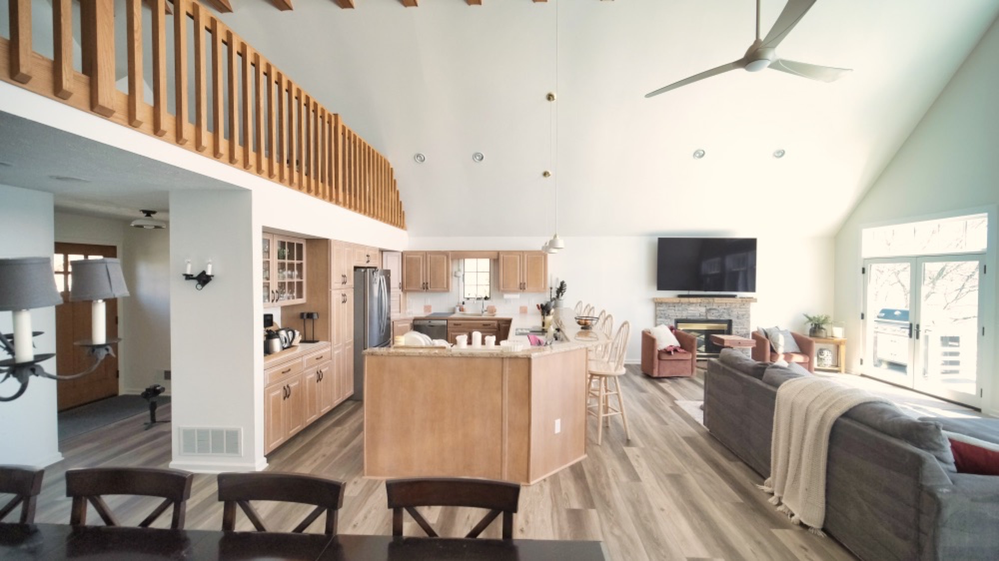 Open-concept great room with vaulted ceiling and a remodeled kitchen in a Wrona Construction renovation